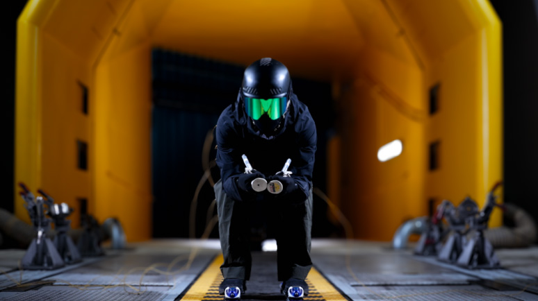 Skier with ski suit in climatic wind tunnel
